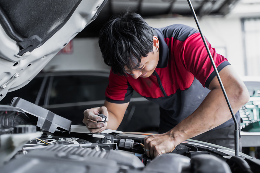 the man who is repairing the car
